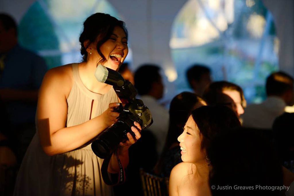 A female photographer laughing with her subject